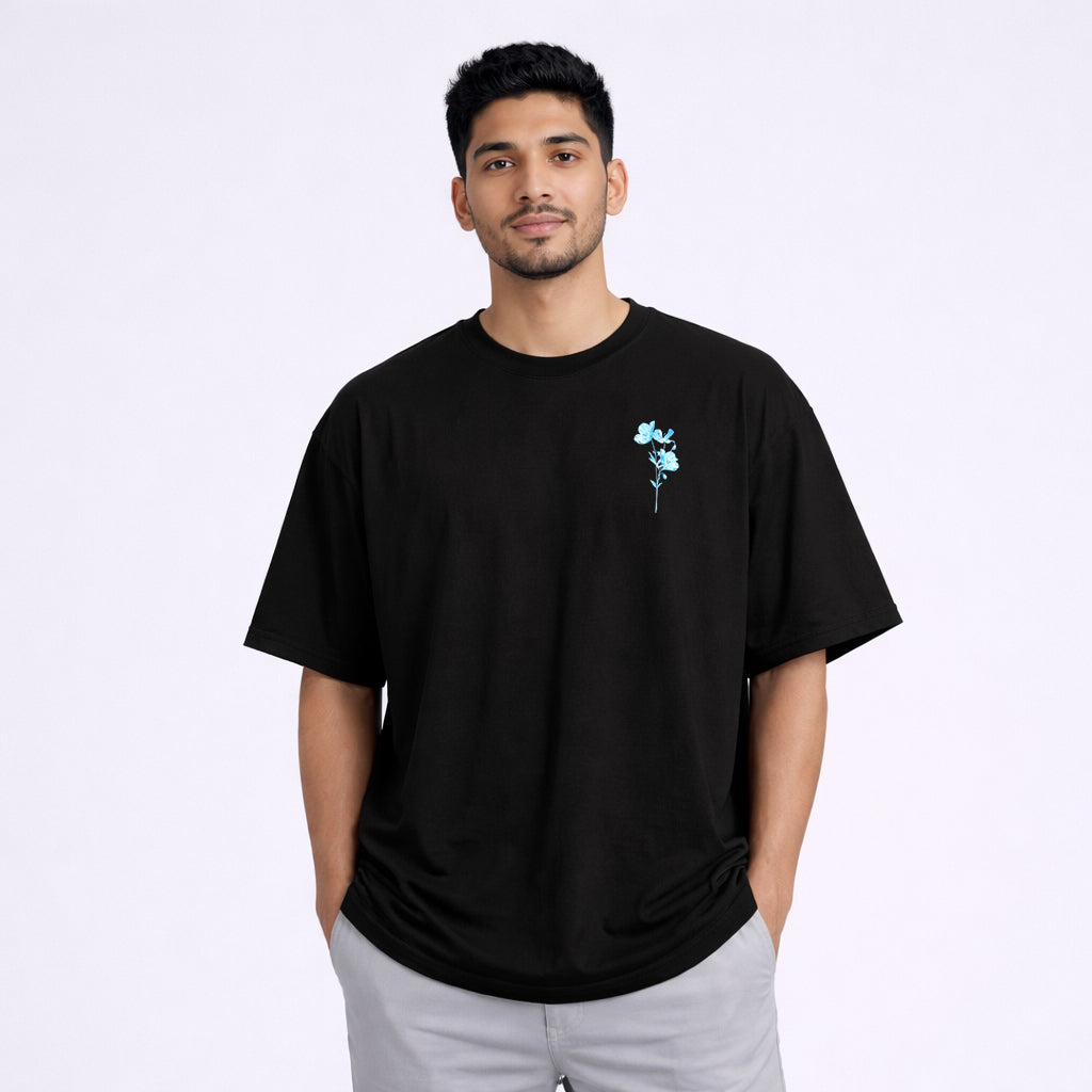 Abol Tabol Chill Oversized Black T-shirt – Front View Model Wearing Blue Floral Chest Print